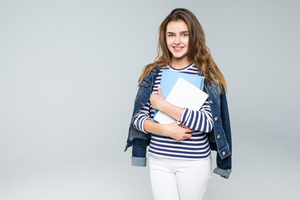 Young smiling student woman over white background